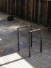 View of Chair piece and a bowl on the floor in the background. Inside gutted church space